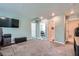 Spacious bonus room with multiple entryways and a wall-mounted television, offering flexibility and entertainment options at 377 Yellow Finch Ln, Henderson, NV 89012