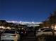 Nighttime view of the bright Las Vegas skyline from a quiet neighborhood street at 377 Yellow Finch Ln, Henderson, NV 89012