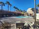 Community pool with lounge chairs and palm trees at 377 Yellow Finch Ln, Henderson, NV 89012