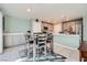 Cozy dining area adjacent to a modern kitchen with granite countertops and stainless steel appliances at 377 Yellow Finch Ln, Henderson, NV 89012