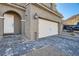 Close up of a home's driveway and entrance with stone pavers and a well maintained two car garage at 377 Yellow Finch Ln, Henderson, NV 89012