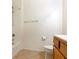 Bathroom featuring a shower, toilet, wood vanity, and beige tile flooring at 38 E Serene Ave # 134, Las Vegas, NV 89123