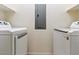 A laundry room featuring a washer, dryer, white walls, and shelving at 38 E Serene Ave # 134, Las Vegas, NV 89123