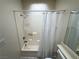 Small, simple bathroom featuring a shower-tub with curtain, white fixtures, and neutral wall colors at 3936 Rive Gauche St, Las Vegas, NV 89115
