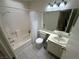 Clean bathroom with a shower-tub combo, single sink vanity, and tile flooring in neutral tones at 3936 Rive Gauche St, Las Vegas, NV 89115