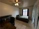 Cozy bedroom featuring a ceiling fan, desk, and window with natural light at 3936 Rive Gauche St, Las Vegas, NV 89115