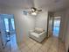 Bedroom with sitting chair and tile floors at 3936 Rive Gauche St, Las Vegas, NV 89115