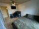 Bedroom with a ceiling fan, TV, desk, and quilted bedspread at 3936 Rive Gauche St, Las Vegas, NV 89115