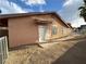 Exterior view of a one-story home, featuring stucco siding, a front door, a fenced yard, and simple landscaping at 3936 Rive Gauche St, Las Vegas, NV 89115
