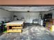 Large open two car garage used as a workspace with various tools, boxes, and appliances at 3936 Rive Gauche St, Las Vegas, NV 89115