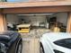 Spacious two car garage with items, including a large work table, shelves, and household appliances at 3936 Rive Gauche St, Las Vegas, NV 89115