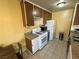 A compact kitchen with white appliances and brown cabinets at 3936 Rive Gauche St, Las Vegas, NV 89115