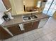 The kitchen with double sink, dishwasher, and tan countertops at 3936 Rive Gauche St, Las Vegas, NV 89115