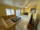 Open-concept living room with a large sectional sofa and tiled floors at 3936 Rive Gauche St, Las Vegas, NV 89115