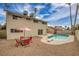 Backyard features a swimming pool, a patio, and an outdoor table and chairs at 4431 El Campana Way, Las Vegas, NV 89121