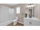 Well-lit bathroom features a tub with shower, a vanity, a sink and a toilet at 4431 El Campana Way, Las Vegas, NV 89121