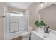 Bathroom with shower/tub combo featuring tiled walls, wood floor and modern fixtures at 4431 El Campana Way, Las Vegas, NV 89121