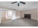Comfortable bedroom featuring a stone fireplace, ceiling fan, and plush carpet flooring at 4431 El Campana Way, Las Vegas, NV 89121