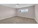 Bright bedroom with neutral walls, carpet, baseboards, and a window view to the outdoors at 4431 El Campana Way, Las Vegas, NV 89121