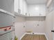Functional laundry room with white cabinets and tile floors at 4431 El Campana Way, Las Vegas, NV 89121