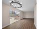 Bright open living room with neutral colors, modern light fixture, and wood-look tile flooring overlooking backyard at 4431 El Campana Way, Las Vegas, NV 89121