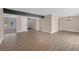 An open concept living room featuring wood-look tile flooring and natural light at 4431 El Campana Way, Las Vegas, NV 89121