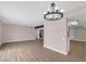 Bright open living room with neutral colors, modern light fixture, and wood-look tile flooring at 4431 El Campana Way, Las Vegas, NV 89121