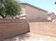 View of backyard area with retaining wall and dirt landscaping at 4825 Shea Stadium Ave, Las Vegas, NV 89139