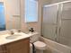 Bathroom with a single sink, toilet, and shower-tub combo enclosed with sliding glass doors at 4825 Shea Stadium Ave, Las Vegas, NV 89139