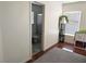 View into a partially-visible bathroom featuring a toilet, shower with glass door, and gray flooring at 4825 Shea Stadium Ave, Las Vegas, NV 89139