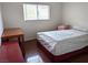 Cozy bedroom with a bed, side table, and a window offering natural light at 4825 Shea Stadium Ave, Las Vegas, NV 89139