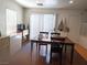 Open dining area with natural light, wooden table, and access to the outdoor patio at 4825 Shea Stadium Ave, Las Vegas, NV 89139