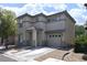 Two-story home with a covered entryway, two-car garage and desert landscaping at 4825 Shea Stadium Ave, Las Vegas, NV 89139