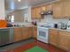 Functional kitchen with wood cabinets, a gas range, and stainless steel dishwasher at 4825 Shea Stadium Ave, Las Vegas, NV 89139