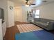 Cozy living room featuring a ceiling fan, a comfortable sofa, and shelving at 4825 Shea Stadium Ave, Las Vegas, NV 89139