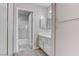 This bathroom features neutral walls, carpet flooring, and white cabinets at 4860 Nara Vista Way # 104, Las Vegas, NV 89103