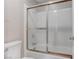 A view of the bathtub and shower with sliding glass doors and a toilet at 4860 Nara Vista Way # 104, Las Vegas, NV 89103