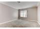 This bedroom features neutral walls, carpet flooring, and a window with blinds at 4860 Nara Vista Way # 104, Las Vegas, NV 89103