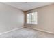 This bedroom features neutral walls, carpet flooring, and a window with blinds at 4860 Nara Vista Way # 104, Las Vegas, NV 89103