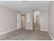 Bedroom with carpet, adjoining bathroom, and neutral paint ready for a new owner at 4860 Nara Vista Way # 104, Las Vegas, NV 89103