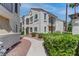 Exterior of a charming stucco home with a tile roof and well-manicured landscaping in a sunny setting at 4860 Nara Vista Way # 104, Las Vegas, NV 89103