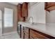 This kitchen features wood cabinets, a white countertop, and a stainless steel faucet at 4860 Nara Vista Way # 104, Las Vegas, NV 89103