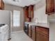 Kitchen featuring white appliances, dark wood cabinets, and a white countertop and sink at 4860 Nara Vista Way # 104, Las Vegas, NV 89103