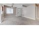 Living room with neutral walls, carpet, a view of the front door, and access to the kitchen at 4860 Nara Vista Way # 104, Las Vegas, NV 89103