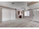 Living room with neutral walls, carpet, ceiling fan, and view into the kitchen and access to the backyard at 4860 Nara Vista Way # 104, Las Vegas, NV 89103