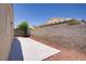Enclosed backyard with concrete patio and low-maintenance landscaping at 5129 Midnight Oil Dr, Las Vegas, NV 89122