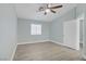 Light blue bedroom features a ceiling fan and natural light from a window at 5129 Midnight Oil Dr, Las Vegas, NV 89122