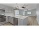 Open concept kitchen with white cabinets, stainless steel appliances, and modern lighting at 5129 Midnight Oil Dr, Las Vegas, NV 89122