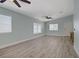 Bright living room featuring wood-look floors, high ceilings and a modern ceiling fan at 5129 Midnight Oil Dr, Las Vegas, NV 89122