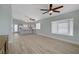 Spacious living room featuring sleek wood floors, recessed lighting, and a modern ceiling fan at 5129 Midnight Oil Dr, Las Vegas, NV 89122